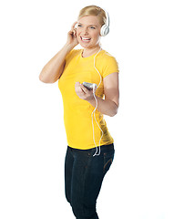 Image showing Pretty woman holding music player