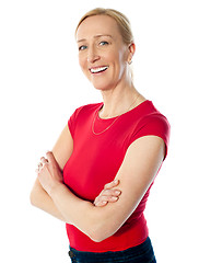 Image showing Smiling middle aged lady, poisng with folded arms