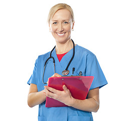 Image showing Experienced female doctor smiling at camera