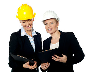 Image showing Young female architects reviewing documents