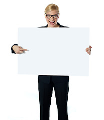 Image showing Saleswoman pointing at blank billboard