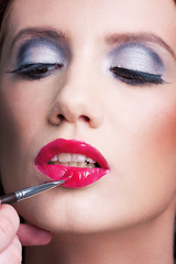 Image showing A make-up artist applying a make-up