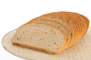 Image showing Fresh bread sliced on a place mats isolated on white 