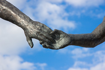 Image showing hand holding statues