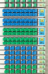 Image showing fiber optic rack with high density of blue and green SC connectors