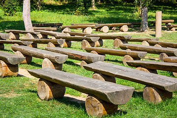 Image showing outdoor wood benches on green lawn