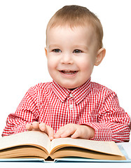 Image showing Little child play with book