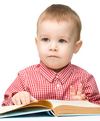 Image showing Little child play with book