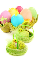 Image showing Colorful Easter eggs and chicks in a nest.