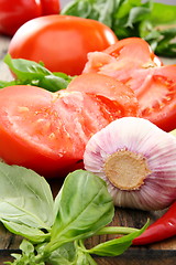 Image showing Ripe tomatoes, garlic and green basil. 