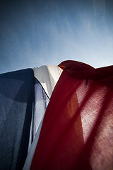 Image showing Dutch wrinkled flag against sun