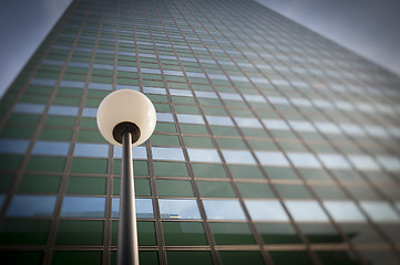 Image showing Lamp post in front office building facade