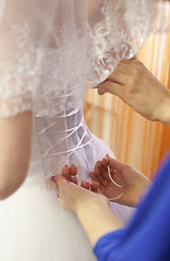 Image showing Pre-ceremony bride dressing