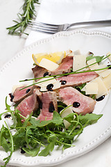 Image showing Beef on arugula salad and parmesan