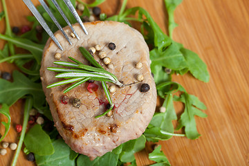 Image showing Cooked piece of beef on arugula salad