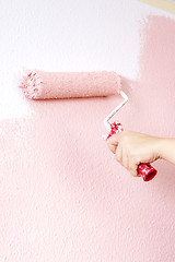 Image showing painting a wall in pink