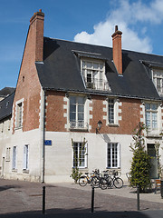 Image showing Bicycles in front of a white tuff, red brick and blue slate buil