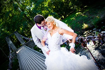 Image showing Happy groom and bride on bridge