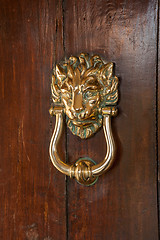 Image showing Lion head door knocker on old wooden door