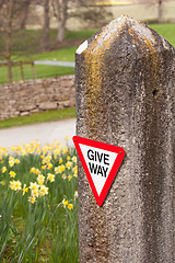 Image showing Give way sign on old stone gatepost