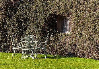 Image showing Garden table and chairs on lawn