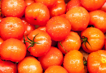 Image showing Ripe tomatoes at market wet with rain