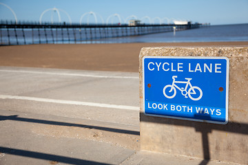 Image showing Blue cycle path lane sign by beach