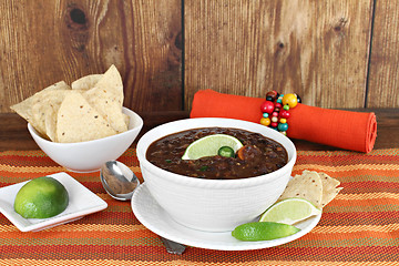 Image showing Black bean mexican soup with chips and lime.