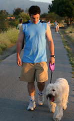 Image showing Man walking with his dog