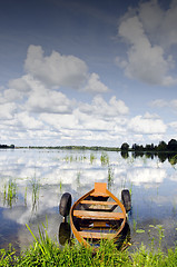 Image showing Lake boat moored tires cloud reflection on water 