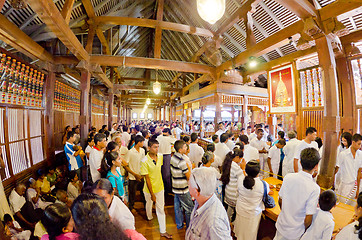 Image showing crowd of worshipers and tourists at the entrance to the room wit