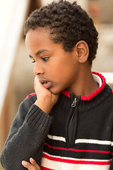 Image showing Portrait of an Ethiopian boy resting his chin on his hands