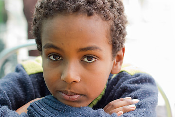 Image showing Portrait of an Ethiopian boy resting his chin on his hands