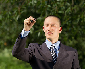 Image showing Businessman Writing Something Outdoors