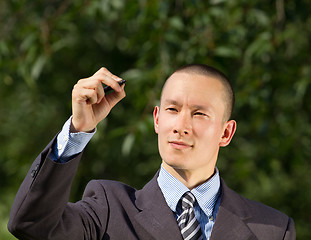 Image showing Businessman Writing Something Outdoors