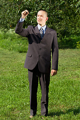 Image showing Businessman Writing Something Outdoors