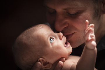 Image showing Young Father Holding His Mixed Race Newborn Baby