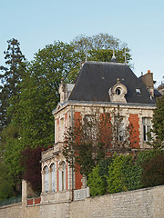 Image showing Typical white tuff, red brick , blue slate building, and trees.