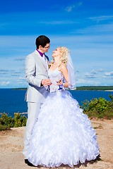 Image showing  happy groom and bride on a sea coast