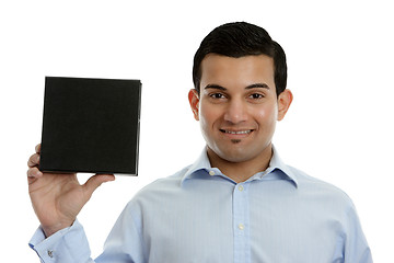 Image showing Salesman holding a product, book or other merchandise