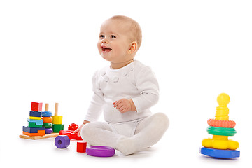 Image showing Small child play with toys on white background