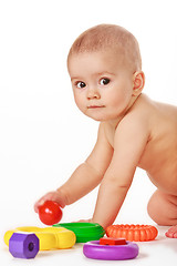 Image showing Small child play with toys on white background