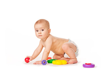 Image showing Small child play with toys on white background