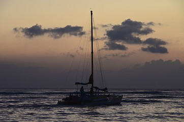 Image showing Small pleasure yacht cruising at sunset