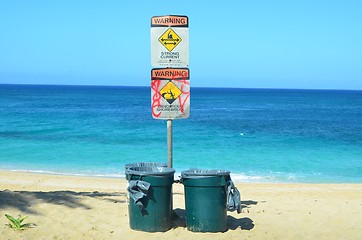 Image showing Beach hazard signs and dustbins