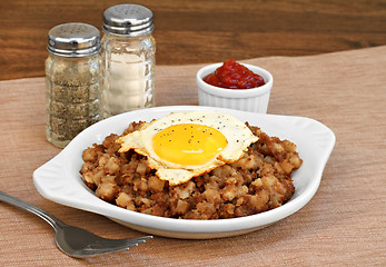 Image showing Fried egg on top of roast beef hash.