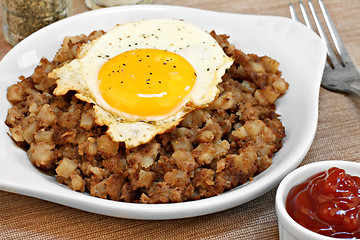 Image showing Fried egg on top of roast beef hash.