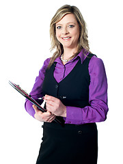 Image showing Portrait of experienced lady writing on clipboard