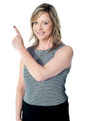 Image showing Gorgeous woman pointing away from camera