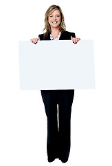 Image showing Senior beautiful woman smiling showing blank white placard